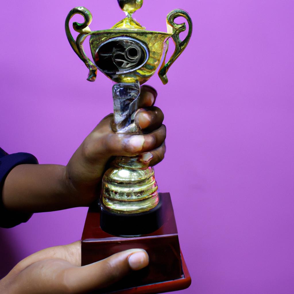 Person holding an award trophy