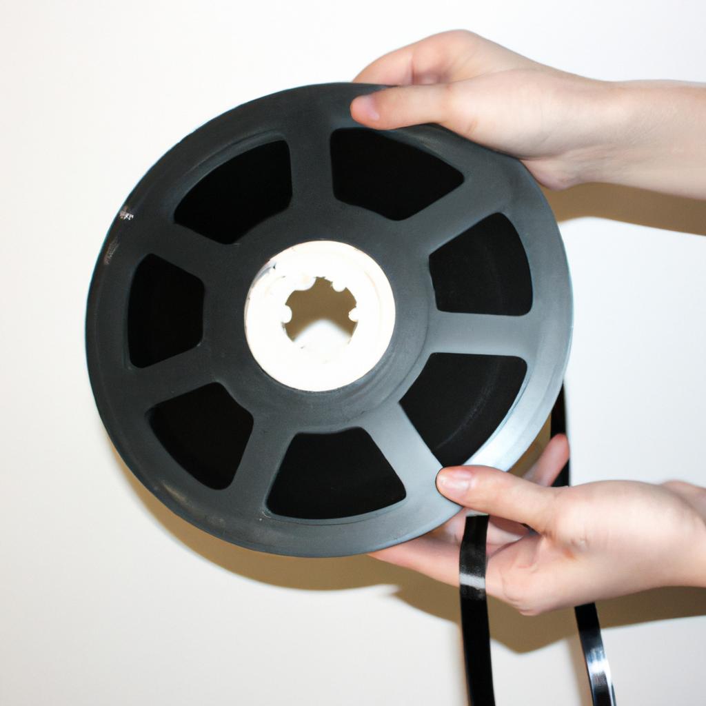 Person holding a movie reel