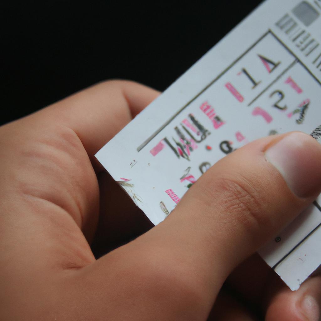 Person holding a movie ticket